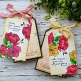 Two tags made with Rustic Whispers paper. Red and yellow florals with 'Where God guides He provides' and 'With His love He will calm all your fears.'