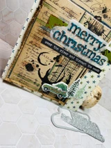 Handmade card layered over Jolande's Ledger, a coffee-stained grungy ledger and newsprint background red rubber stamp from Unity Stamp Co, topped with florals and a Christmas sentiment.