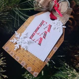 Scandinavian deer-pattern kraft tag with a die-cut snowflake and 'FA LA LA'.