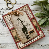 Kraft tag of the script deer with a Peace label on plaid and holly patterned papers.