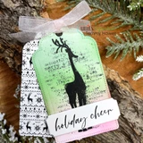 Holiday cheer tag of the script deer on a green ombre background with Nordic deer borders.