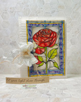 Textured white card with the stained glass rose coloured in deep red and green and 'Let your light shine through' on a kraft strip.