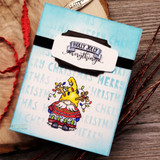 Card with the gnome on a blue 'Merry Christmas' word background, 'Holly Jolly everything.'