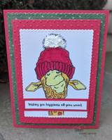 Bright card with the giraffe in a magenta beanie and 'Wishing you happiness all year round.'