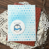 Soft blue polka-dot card with a single penguin in a circle frame layered on kraft, 'let's chill.'