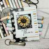 Card with a yellow grunge daisy over black patterned paper and 'HEY There.'