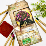 Grungy tag with a magenta rose, ink and 'flower' ephemera.
