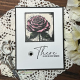 Clean white card with a single stamped rose and the word 'There, is love in every moment.'