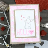 Pink and grey card with a heart patterned background panel, a white bunny coloured in the centre, a large "HELL" and "O" split greeting and a cutie pie tag.