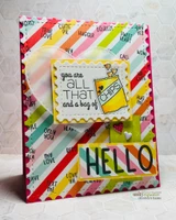 Rainbow striped card with the word stamps repeated across the background, a yellow lemon panel with a sentiment and a large stamped "HELLO" along the bottom edge.