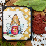 Card with mustard polka dot papers on a doily, a beehive with bees coloured in the centre and the chatty word stamps forming the striped background panel.