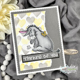 Grey and yellow card with a heart patterned panel, a donkey coloured in soft grey with a butterfly and a thinking of you strip in a black frame.