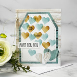 Teal and gold heart card in a tag shape, hearts stamped in aqua and gold across the panel with a happy for you strip and a small swirl die cut.