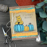 Card sample — Pooh bear with blue pumpkins, 'it's a thankful sort of day!', on kraft-toned cardstock.