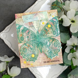 Vintage card with the butterfly in teal over collage paper: 'You are wonderful.'