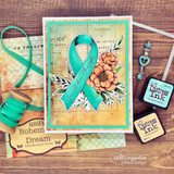 Handmade card featuring the floral awareness ribbon surrounded by blooms, in teal with vintage layers, stamped with 'Sending you strength & love in your brave journey'.