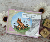 Card of Tigger sitting in a flowery meadow, 'here for you as you bounce back.'