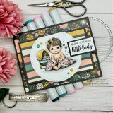 Card with the colored baby girl on a striped panel with 'Welcome to the world little lady.'
