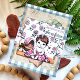 Gingham-framed card with the baby girl over floral papers and 'though she be little she is fierce.'
