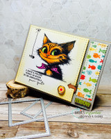 Fish-tape bordered card of the smiling cat with a paw-print arrow and dies beside