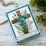 Teal-bordered card of the cross with blue poppies and 'Appreciating they say what hits you're not alone'