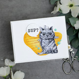 White card with the grey cat on a yellow heart, 'Sup?' in a speech bubble beside him.