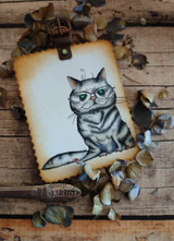 Vintage-toned card with the bespectacled cat stamped on aged kraft paper inside a clipboard-style frame.