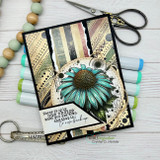 Black and kraft mixed-media card with a teal coneflower and a stamped sentiment strip, styled with markers and scissors.