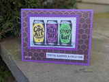 Beer-can trio in cool colors on a purple honeycomb-print card, 'You've earned a cold one.'