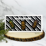 Beer-can trio on black diagonal stripes, 'You've earned a cold one,' slimline card.