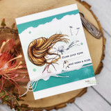 Torn-edge teal card of the brunette girl blowing seeds with 'Close your eyes and make a wish.'