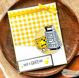 Card on yellow gingham with a golden cheese wedge and grey grater on a kraft circle, above 'HAVE A GRATE DAY.'