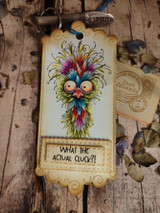 Kraft tag on weathered wood with the frazzled chicken and the "What the actual cluck?!" sentiment