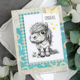 Card with the shaggy pony in soft gray on stitched paper layers with a 'Smooches' speech-bubble sentiment.
