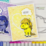Yellow pony in a heart frame on purple and yellow paisley papers with a 'Hay girl!' speech bubble.