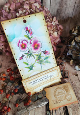 Sky-blue watercolor tag with rosy pansies among fall berries