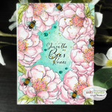 Card of watercolored pink peonies with bees on a teal center, 'You're the Bee's Knees' lettered in the middle.