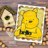 Card sample — a classic golden Pooh bear with 'hello', layered on aged Pooh's Vintage Storybook patterned paper.