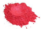 A loose mound of Pink Peony Punch mica pigment powder in a vivid shimmering pink, photographed on white.