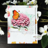 Butterfly-papered card with the monarch on a pink hydrangea collage and the feelings sentiment
