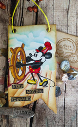 Kraft tag card with the mouse at the wheel and 'Keep Moving Forward.'