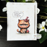 Card with the party-hat cat colored orange beside a cupcake, captioned 'at least you still have one life left.'