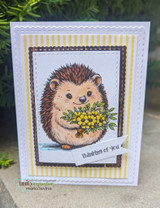 Yellow-striped card of the hedgehog with golden flowers and 'thinking of you' flag