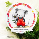 A cute mouse in overalls holding a flower stamped in red rubber and colored on a handmade card reading "Sending a little love your way."
