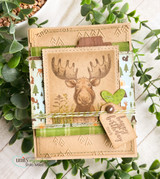 Kraft card with a tonal stamped moose and wildflowers, greenery around it