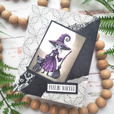 Card with a colored witch figure and "Feelin' wicked" on a black panel