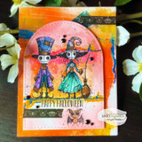 Bright orange arched card with top-hat ghoul figures, "Happy Halloween," wood-bead accents