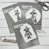Two black chevron cards with sketched ghoul and scarecrow figures and "Happy Halloween"