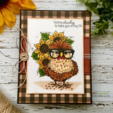 Brown buffalo-check card with the autumn-toned hen in glasses standing on soil