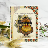 Card of a fluffy chicken wearing sunglasses beside a sunflower, 'just a little chick to say hi.'